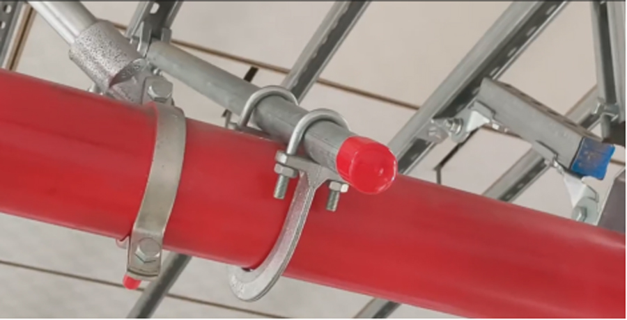 On-site finished installation photo of UTT18 seismic pipe clamp fixed on red fire protection pipeline